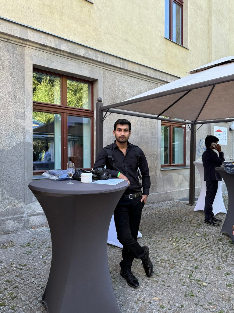 Nanda Kishore Ghosh, event photographer in Berlin, standing with his camera gear at TU Berlin's GPE Farewell Party 2026